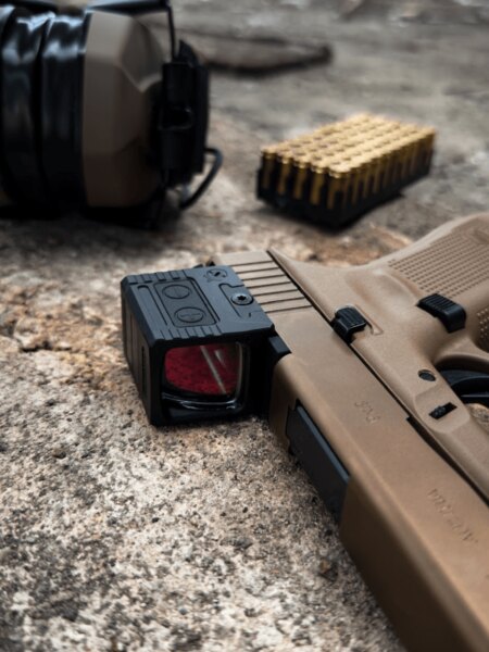 Detail uzavretého kolimátoru Holosun namontovaného na pištoli Glock 19X.